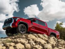 Red Toyota Tundra climbing rocks