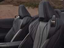 2026 Lexus LC 500 Convertible in red on a coastal road at sunset