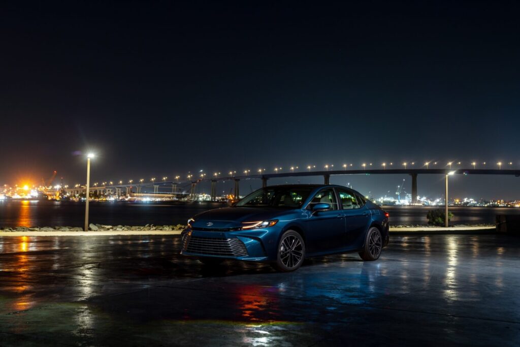 Toyota Camry XLE in Ocean Gem at night by a bridge