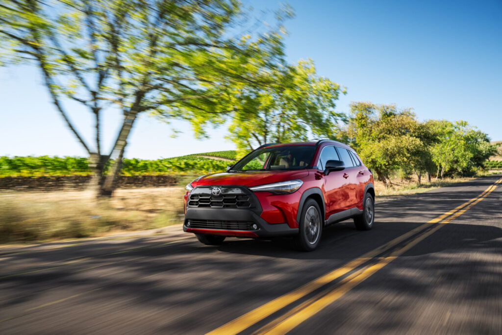 Toyota Corolla Cross XLE AWD in Soul Red Crystal on a country road