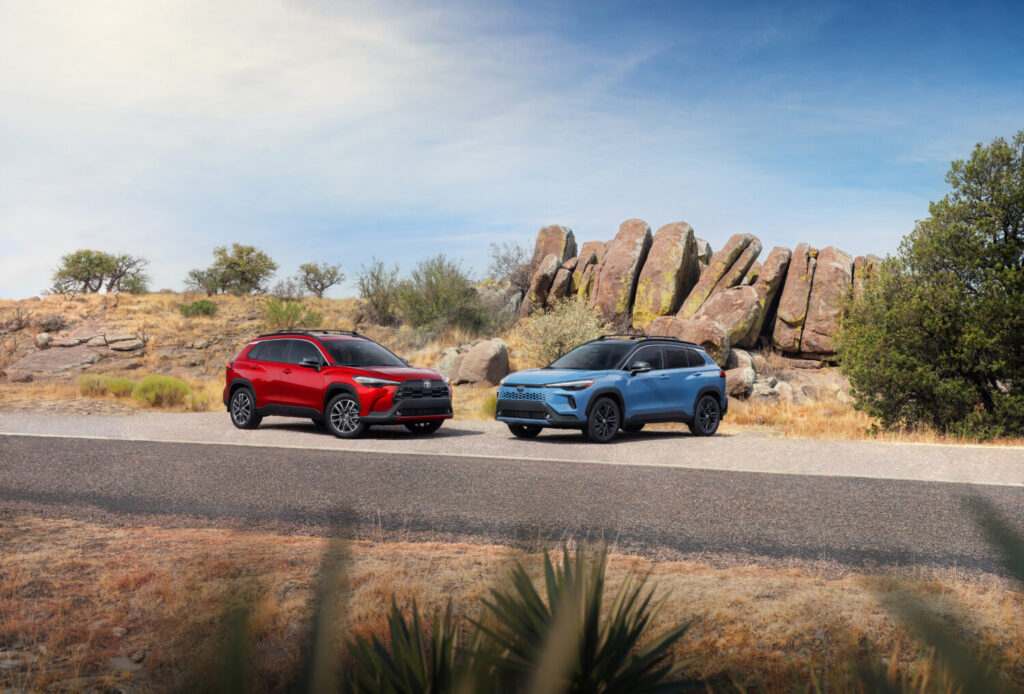 Toyota Corolla Cross and Corolla Cross Hybrid parked by desert rocks