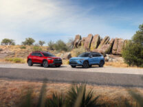 Toyota Corolla Cross and Corolla Cross Hybrid parked by desert rocks